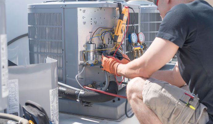 a professional working on a large air conditioning unit