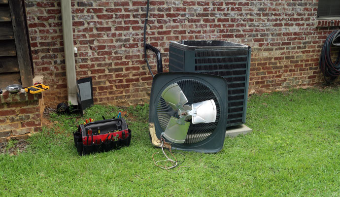 A disassembled HVAC unit with tools