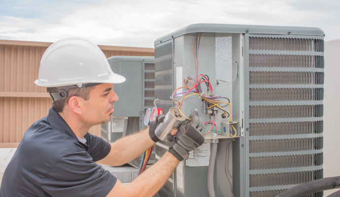 HVAC technician repairing an air conditioning unit