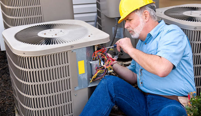 Technicians are repairing an HVAC system