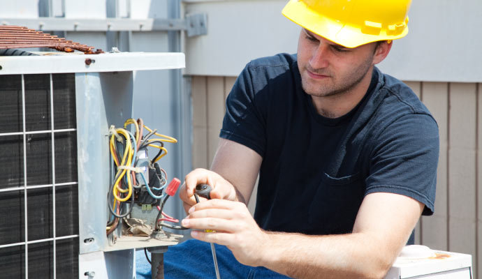 Technicians are repairing an outdoor AC unit