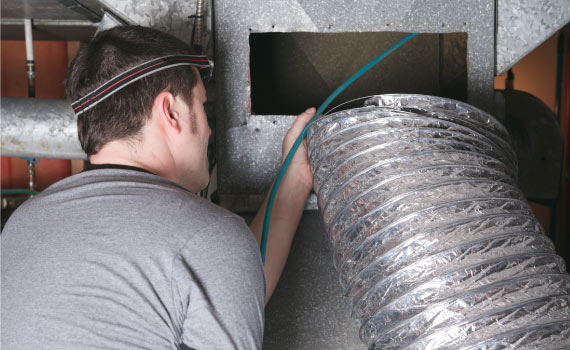 A professional inspecting Duct System