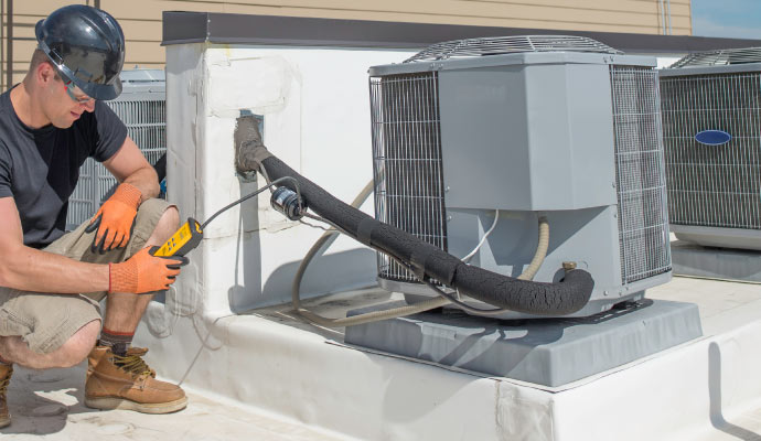 Professional inspecting HVAC system